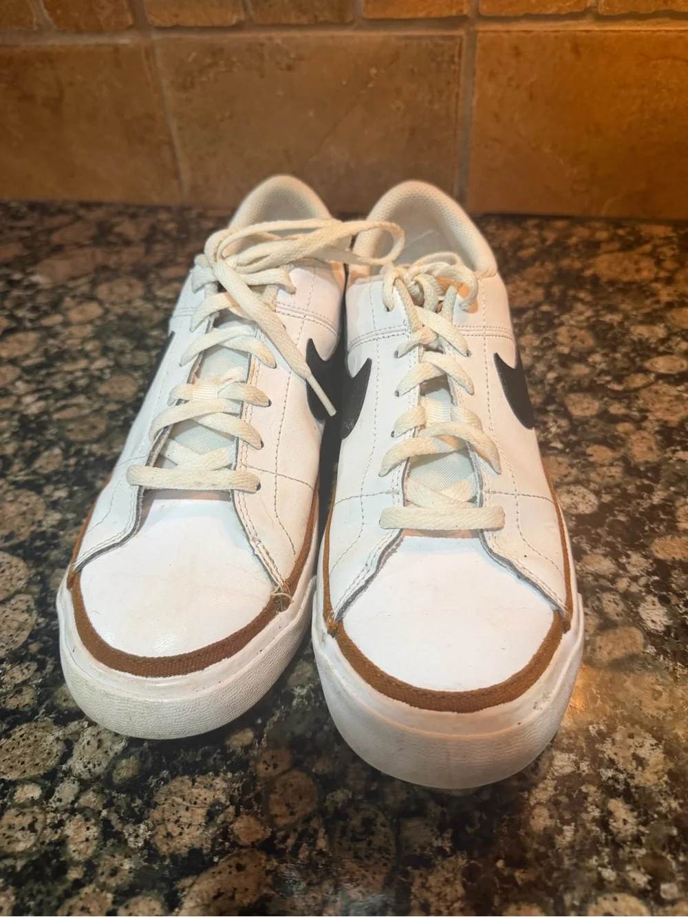 Nike White Low-Top Sneakers with Black Swoosh and Brown Trim